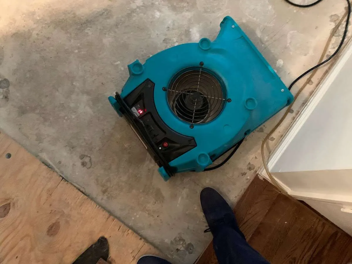 Air mover drying subfloor during Commercial Water Damage Restoration in Huntley